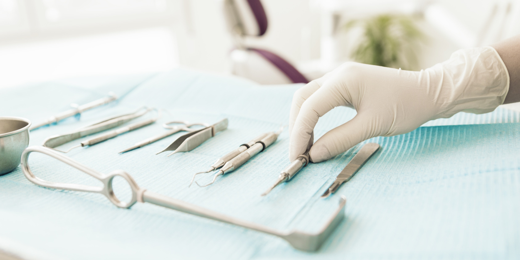 Detail of hand holding dental tools in dental clinic. Dentist Concept.